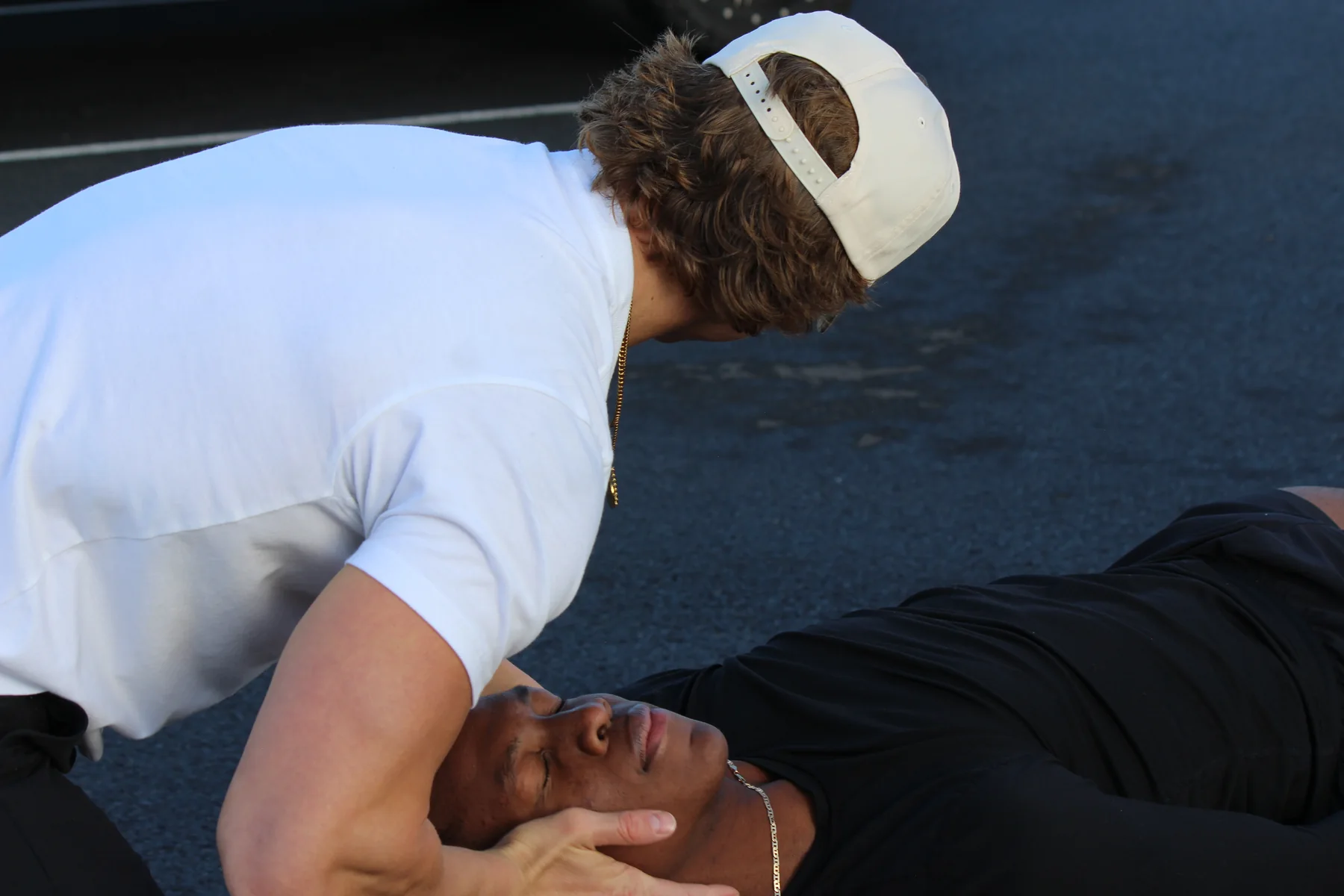 Dr. Bridger Cutler providing hands-on chiropractic care outdoors